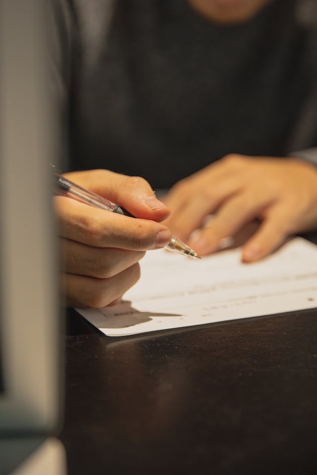 a person filling out a form,